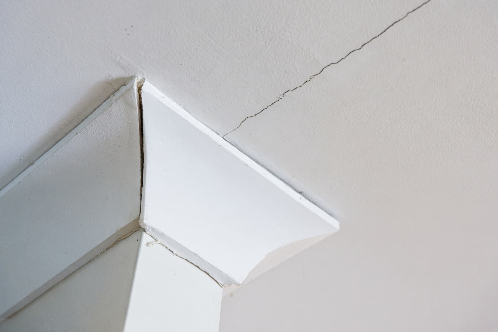 Ceiling drywall cracks along a seam in a Raleigh home before repair
