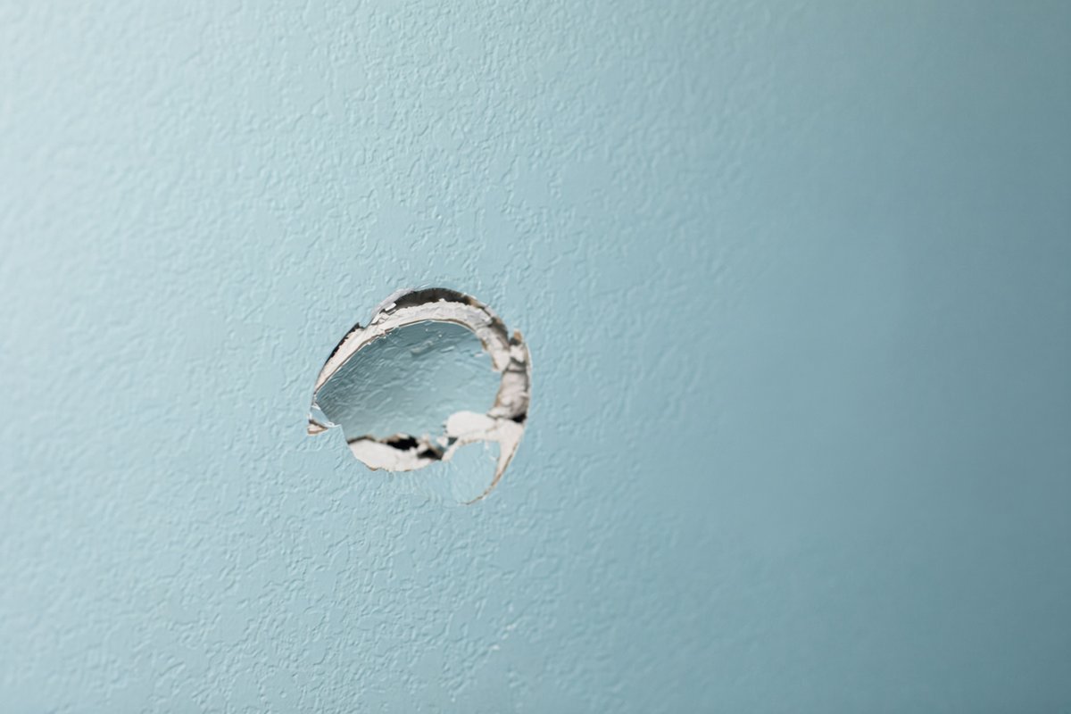 Repairing a doorknob hole in a Raleigh home's drywall