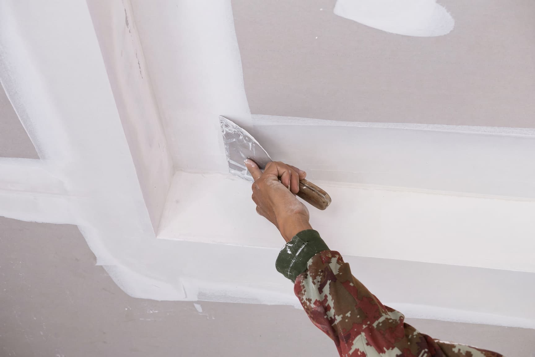 Cracked lath-and-plaster ceiling in a historic Raleigh home being repaired