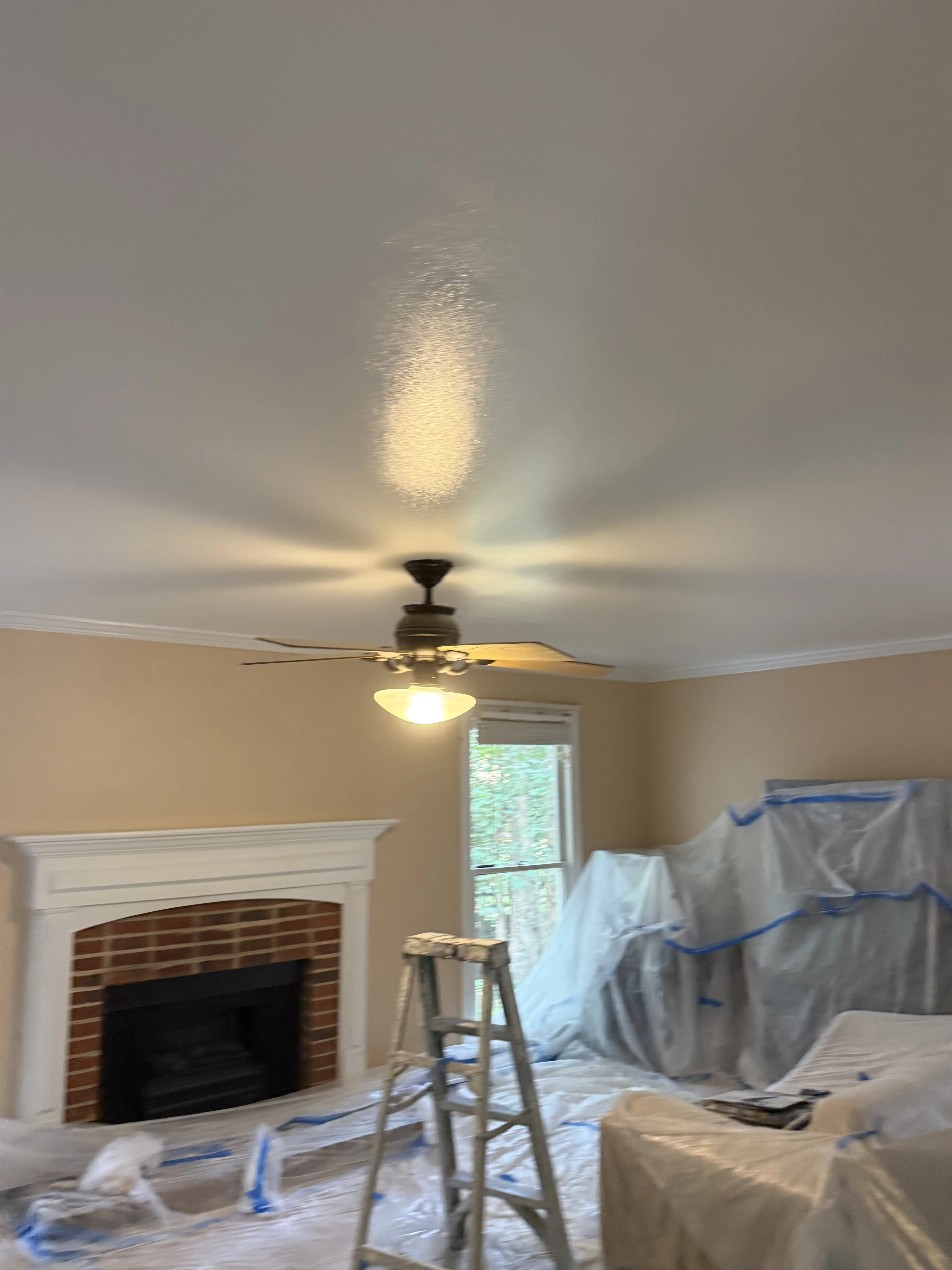 Smooth skim-coated ceiling in a bright Raleigh living room