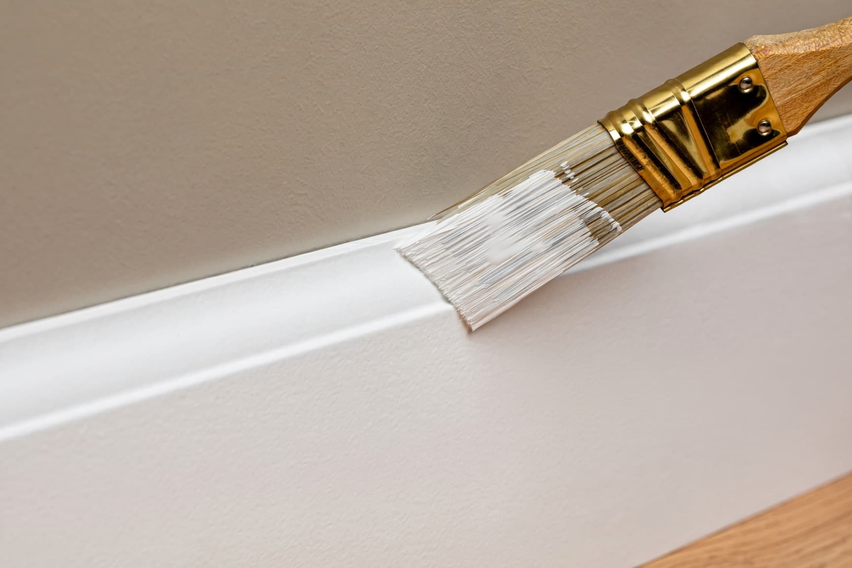Freshly painted white baseboards and interior door trim in a Raleigh home